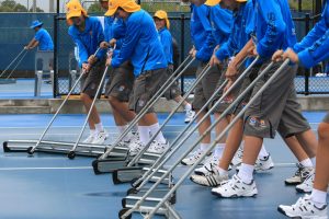 TENNIS - BRISBANE INTERNATIONAL - QUEENSLAND - AUSTRALIA 3rd January 2010. The Ball Kids are put to use with the court squeegee' s during the rain delay at the Brisbane International on Pat Rafter Arena. This image is for Editorial Use Only. Any further use or individual sale of the image must be cleared by application to the Manager Sports Media Publishing (SMP Images). PHOTO : SCOTT POWICK SMP IMAGES STAFF