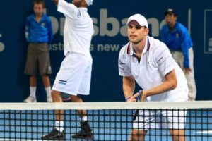 James Blake serving, his doubles-partner Andy Roddick awaits