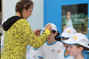 Anastasia Pavlyuchenkova signs the caps of young fans.