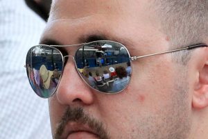 A handle-bar-moustache-d fan watching on from Court 1.