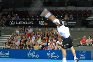 Baghdatis extends his arm for the serve.