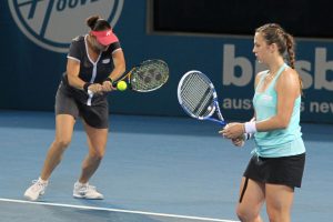 Alisa Kleybanova hammers a backhand while Anastasia Pavlyuchenkova looks on. SMP IMAGES