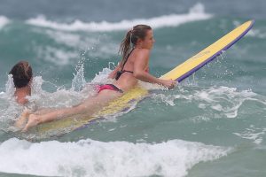 Daniela Hantuchova hits the waves with pro surfer Julian Wilson. Sunshine Coast, Queensland. GETTY IMAGES.