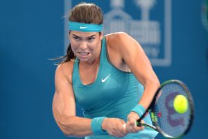 BRISBANE, AUSTRALIA - JANUARY 06: Ajla Tomljanovic of Croatia plays a backhand in her match against Elina Svitolina of the Ukraine during day three of the 2015 Brisbane International at Pat Rafter Arena on January 6, 2015 in Brisbane, Australia.  (Photo by Bradley Kanaris/Getty Images)