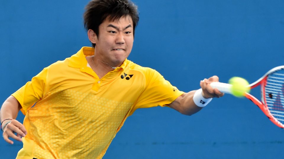 Yoshihito Nishioka of Japan hits a return against Ernests Gulbis. Picture: GETTY IMAGES