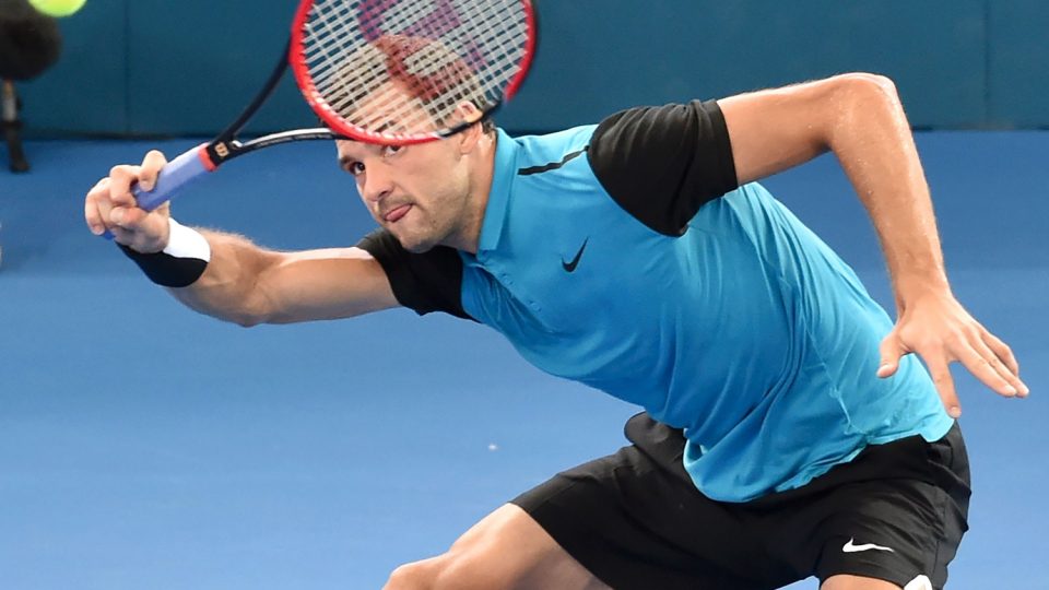 Bulgaria's Grigor Dimitrov slides into a forehand against Giles Simon of France. Picture: GETTY IMAGES