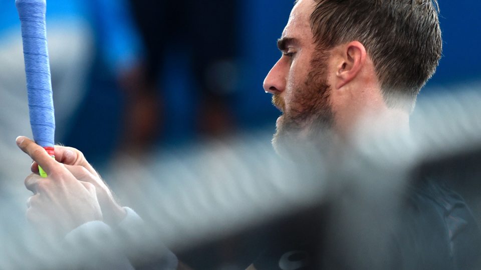 Steve Johnson of the US regrips his racket between sets. Picture: GETTY IMAGES