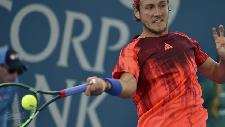 Lucas Pouille of France hits a return against Belgium's David Goffin. Picture: GETTY IMAGES