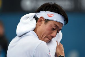 Kei Nishikori wipes his face in the heat at the Brisbane International - PHOTO: Getty Images