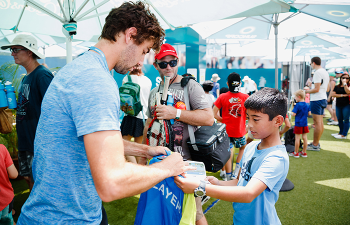 Australian Jordan Thompson meets a young fan at the Queensland Tennis Centre